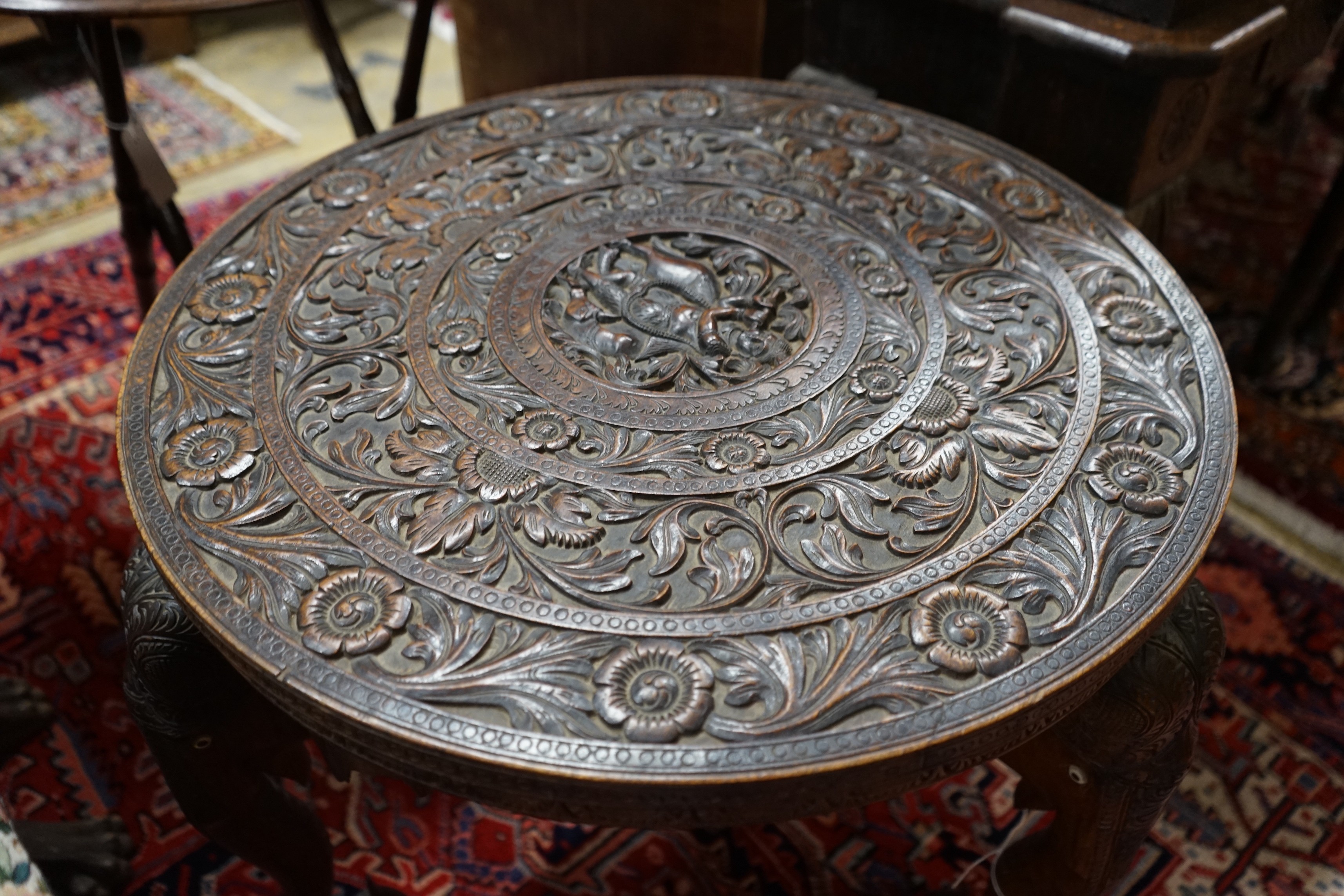 An Indian circular carved hardwood occasional table, diameter 60cm, height 63cm